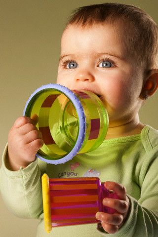 Baby playing with toys --- Image by © John-Francis Bourke /Corbis